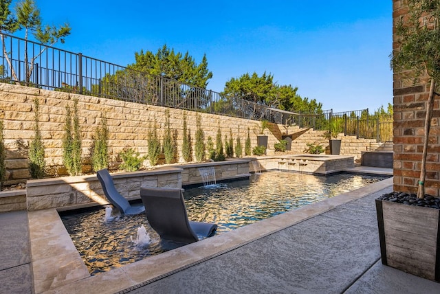 view of pool featuring an in ground hot tub, a fenced backyard, and a fenced in pool