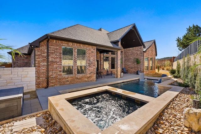 view of swimming pool featuring an in ground hot tub, a fenced backyard, and a patio