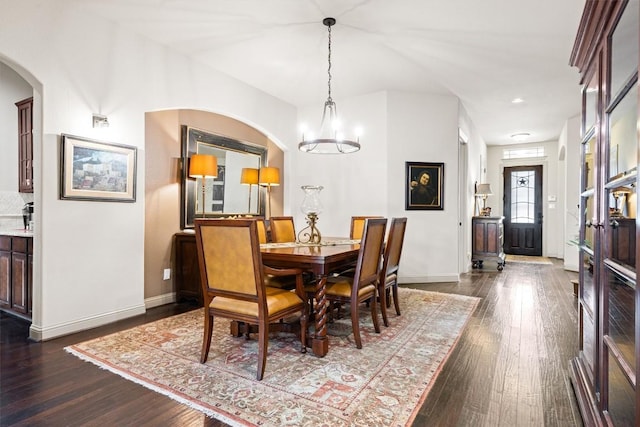 1428 Rowan Dr, Georgetown, TX 78628 - dining space with baseboards, dark wood-style floors, and arched walkways