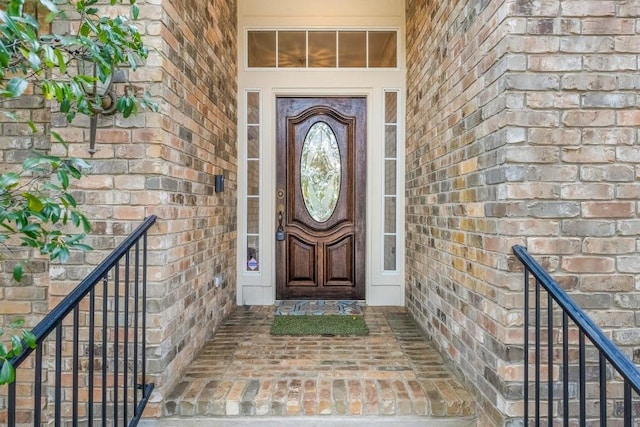 view of exterior entry with brick siding