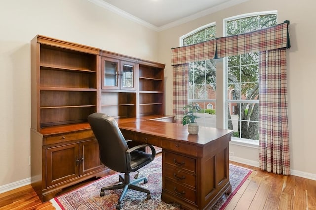 office with ornamental molding, plenty of natural light, and light wood-style flooring