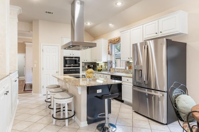 kitchen featuring island exhaust hood, light tile patterned floors, visible vents, a sink, and black appliances