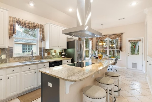 kitchen with decorative backsplash, a sink, island exhaust hood, and black appliances