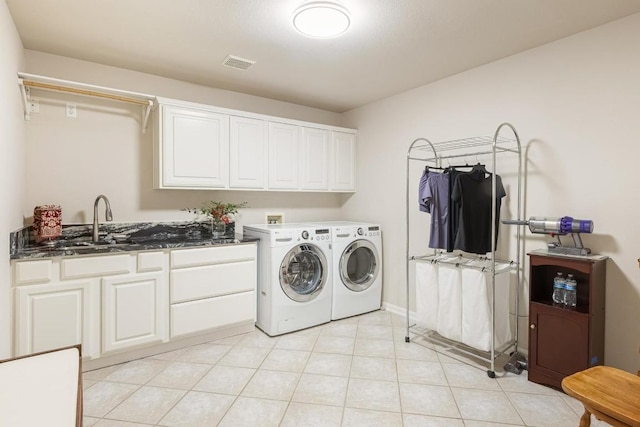 clothes washing area featuring washing machine and clothes dryer, light tile patterned floors, cabinet space, visible vents, and a sink