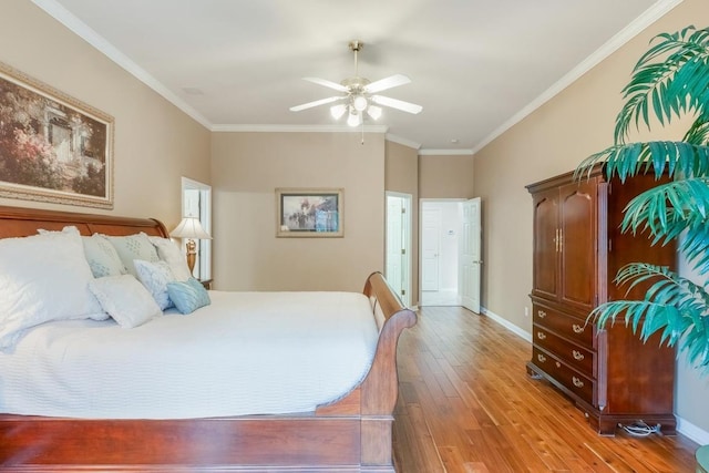 bedroom with ceiling fan, baseboards, crown molding, and wood finished floors