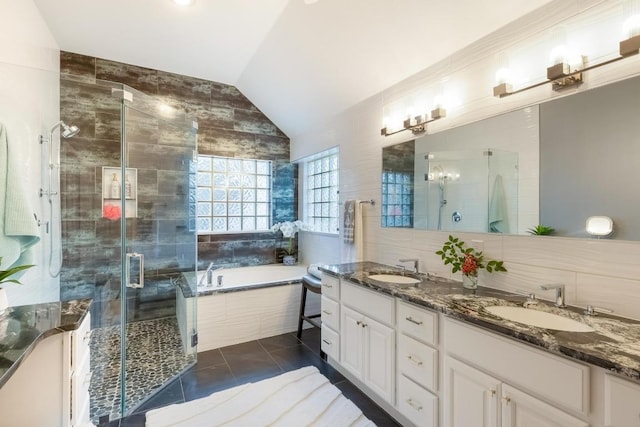 full bathroom featuring a stall shower, a sink, and tile patterned floors