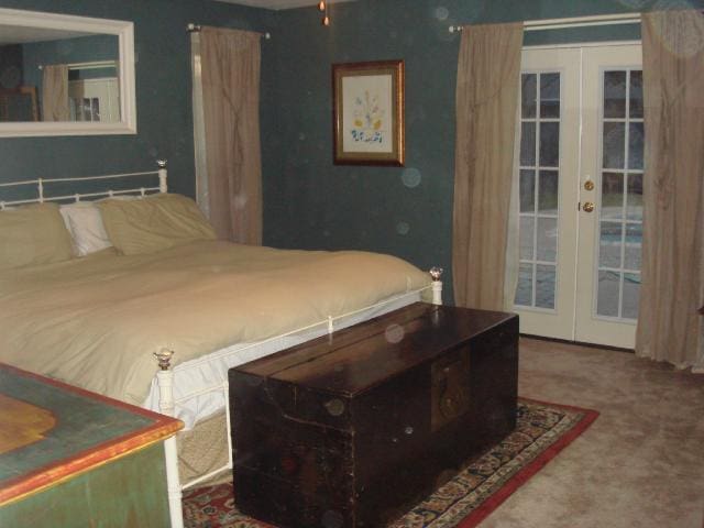 bedroom with access to exterior, french doors, and carpet flooring