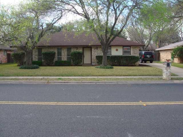 ranch-style home with a front yard and driveway