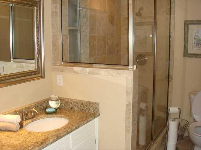 full bathroom featuring vanity, a shower stall, and toilet