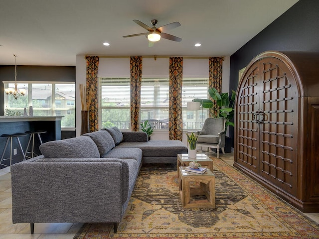 living area featuring ceiling fan with notable chandelier, a wealth of natural light, and recessed lighting