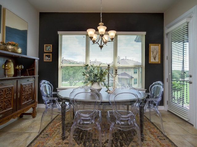 dining room featuring baseboards and a notable chandelier