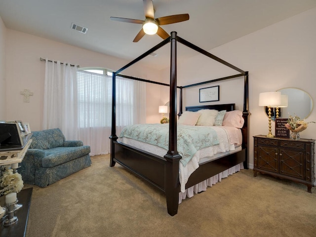 bedroom with carpet, visible vents, and ceiling fan