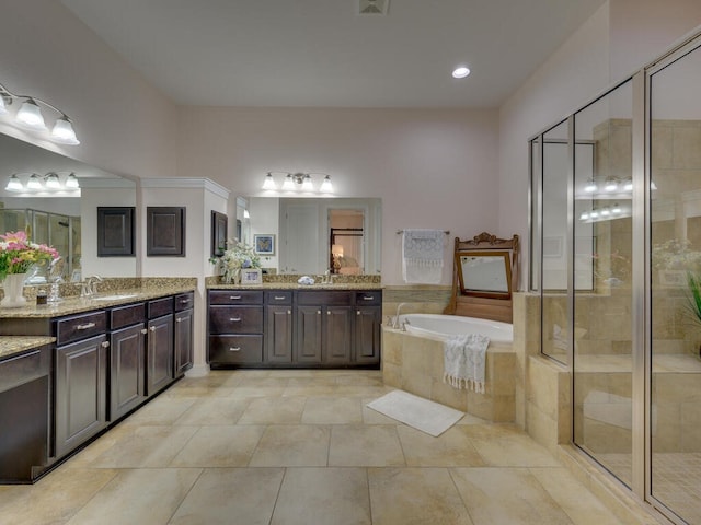 bathroom with two vanities, a garden tub, a sink, and a shower stall