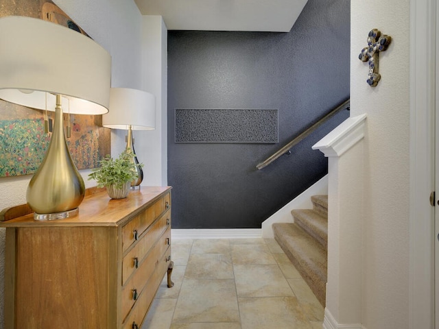 stairs featuring tile patterned flooring and baseboards