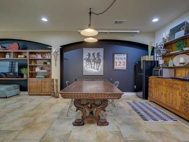 dining space with visible vents, arched walkways, and recessed lighting