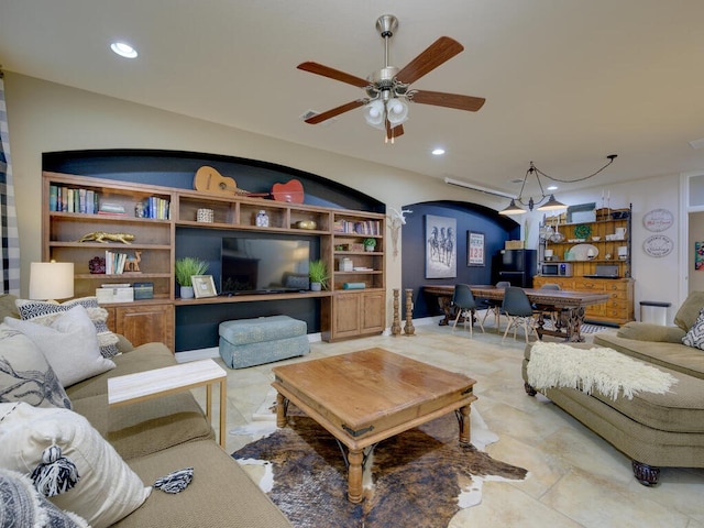 living area with a ceiling fan, arched walkways, and recessed lighting