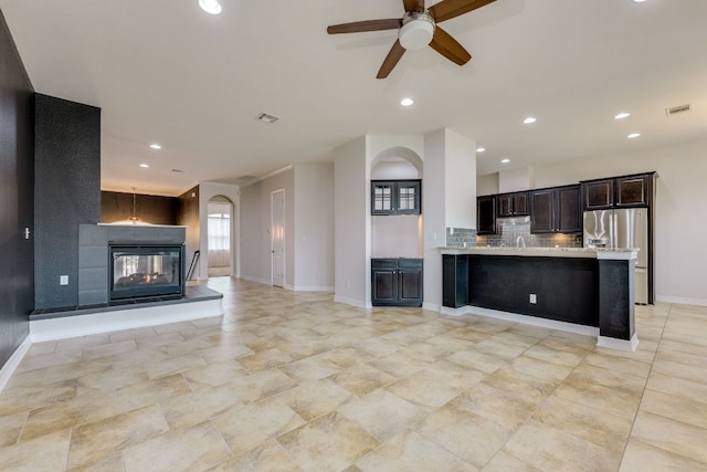 804 San Remo Blvd Unit 26B, Lakeway, TX 78734 - kitchen with open floor plan, stainless steel fridge with ice dispenser, light countertops, ceiling fan, and decorative backsplash