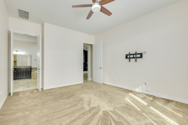 804 San Remo Blvd Unit 26B, Lakeway, TX 78734 - unfurnished bedroom with visible vents, a ceiling fan, ensuite bath, baseboards, and light colored carpet
