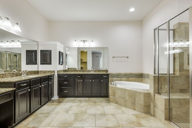 804 San Remo Blvd Unit 26B, Lakeway, TX 78734 - full bath featuring a bath, a shower stall, two vanities, and a sink