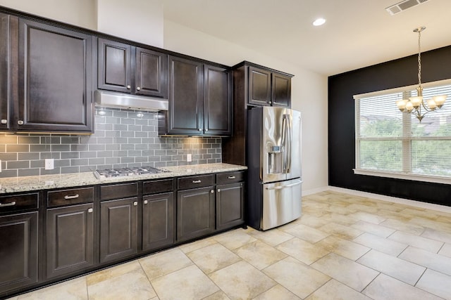 804 San Remo Blvd Unit 26B, Lakeway, TX 78734 - kitchen featuring stainless steel appliances, tasteful backsplash, visible vents, an inviting chandelier, and under cabinet range hood