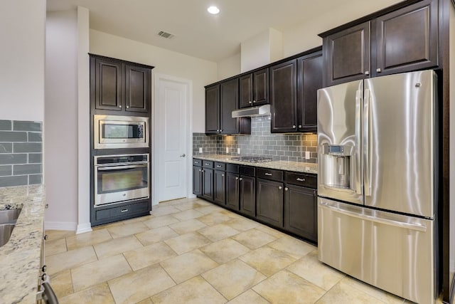 804 San Remo Blvd Unit 26B, Lakeway, TX 78734 - kitchen featuring stainless steel appliances, visible vents, backsplash, and light stone counters