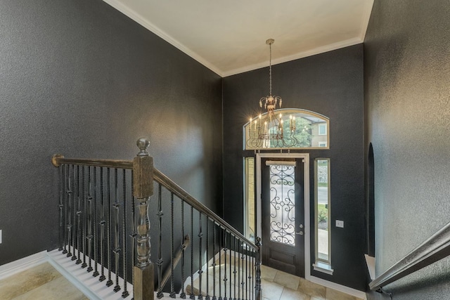 804 San Remo Blvd Unit 26B, Lakeway, TX 78734 - entryway featuring a textured wall, baseboards, an inviting chandelier, and ornamental molding