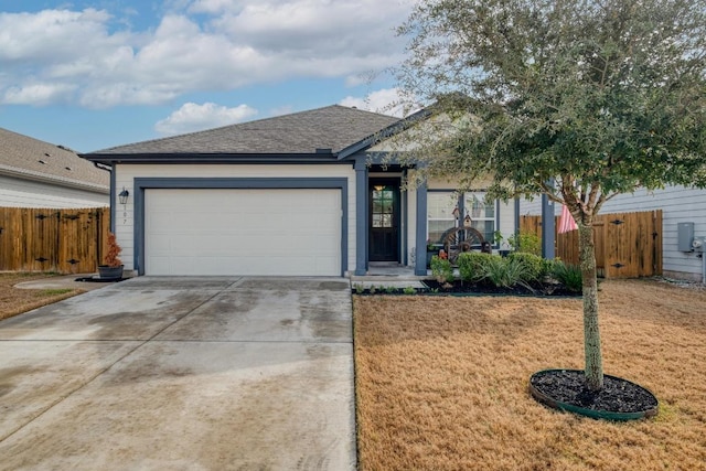 ranch-style home featuring concrete driveway, a front yard, an attached garage, and fence