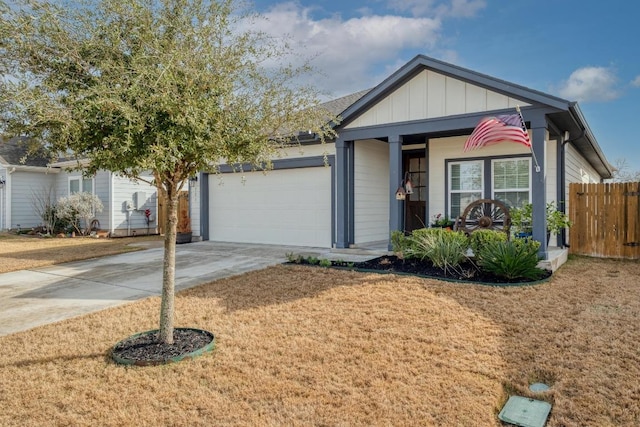 ranch-style house featuring board and batten siding, a front lawn, fence, concrete driveway, and an attached garage