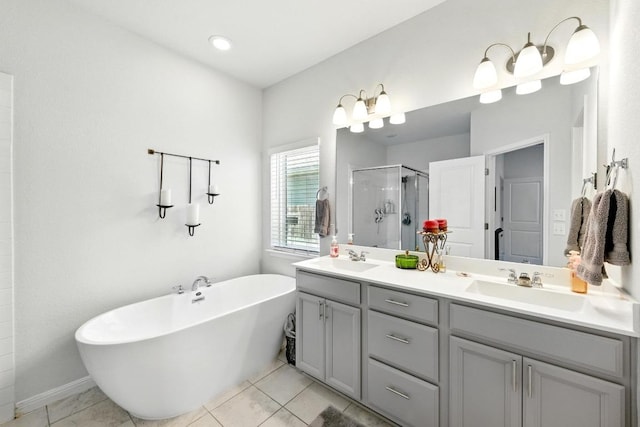 107 Trailside Ln, Bastrop, TX 78602 - bathroom with a shower stall, double vanity, a freestanding tub, and tile patterned floors