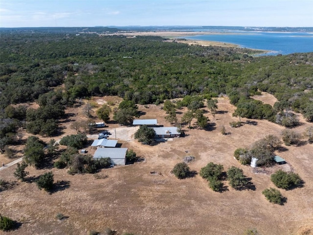 birds eye view of property with a water view and a view of trees