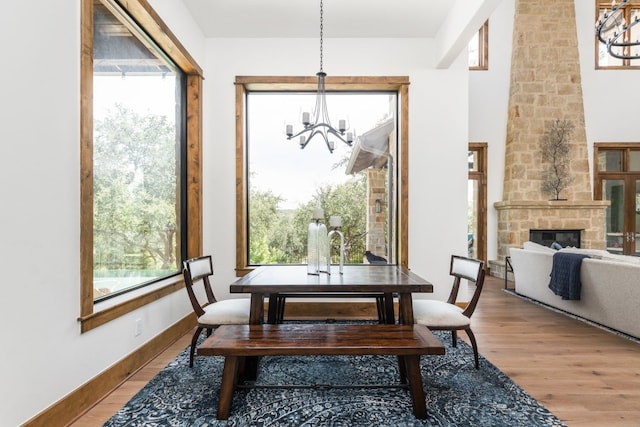 dining room featuring plenty of natural light, wood finished floors, and an inviting chandelier