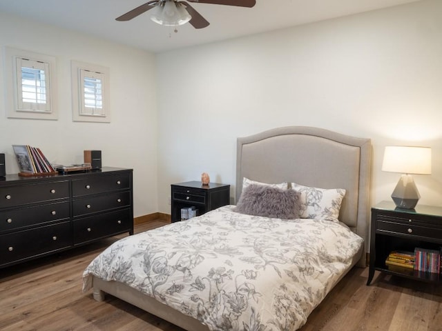 bedroom with baseboards, a ceiling fan, and wood finished floors