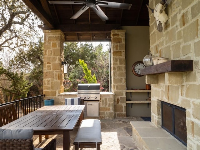 view of patio / terrace with ceiling fan, outdoor dining space, an outdoor kitchen, and a grill