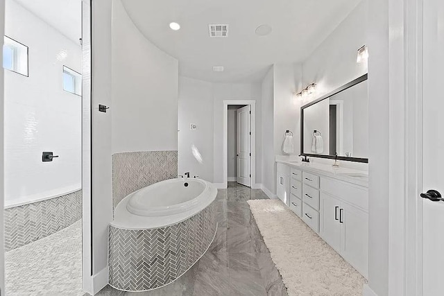 bathroom featuring double vanity, visible vents, a sink, marble finish floor, and a bath