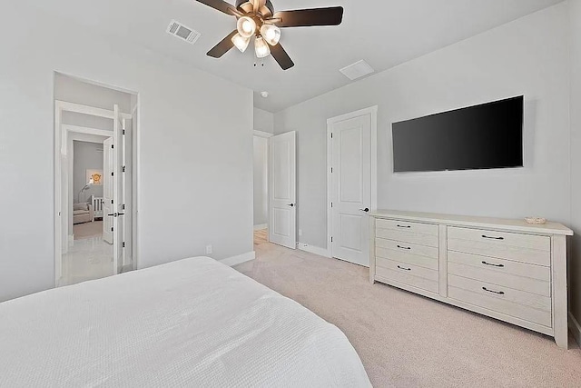 bedroom with light carpet, ceiling fan, visible vents, and baseboards