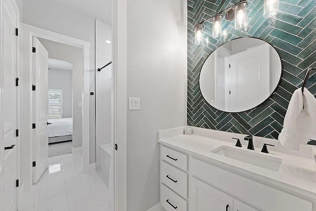 bathroom featuring marble finish floor, ensuite bath, and vanity