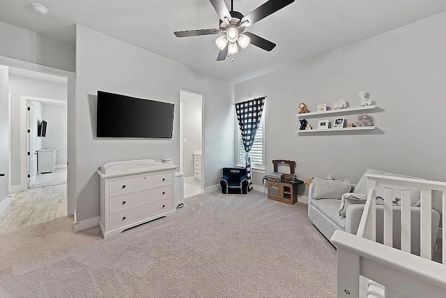 bedroom with ceiling fan, ensuite bath, carpet flooring, and baseboards