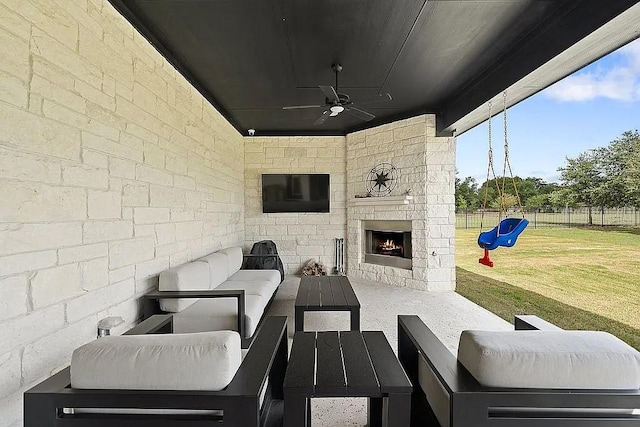 view of patio / terrace featuring fence, an outdoor living space with a fireplace, and ceiling fan