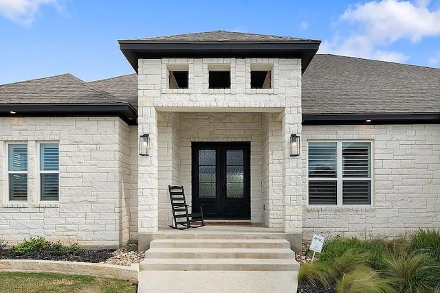 property entrance with a shingled roof and french doors