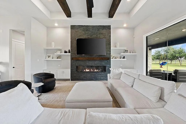 living room featuring recessed lighting, beam ceiling, and a stone fireplace