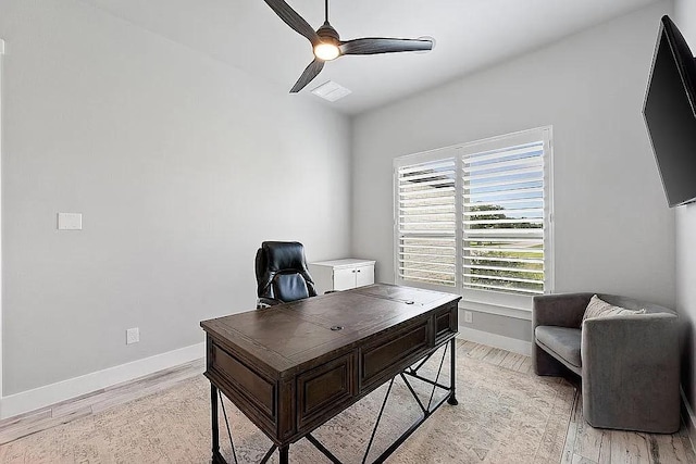 home office featuring a ceiling fan, light wood-style flooring, and baseboards