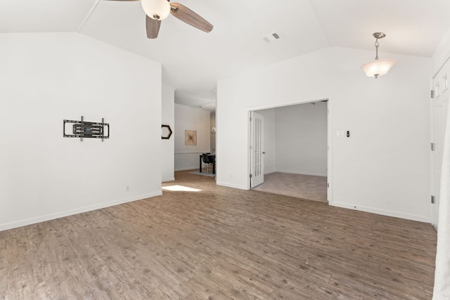 unfurnished room featuring lofted ceiling, a ceiling fan, visible vents, and wood finished floors