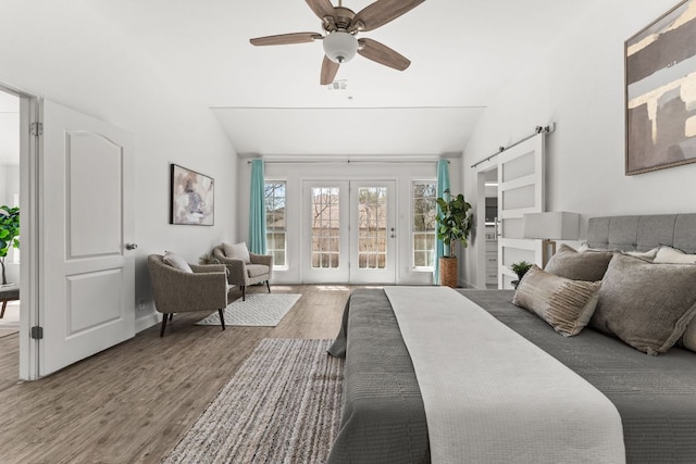 bedroom with a ceiling fan, lofted ceiling, wood finished floors, access to exterior, and french doors