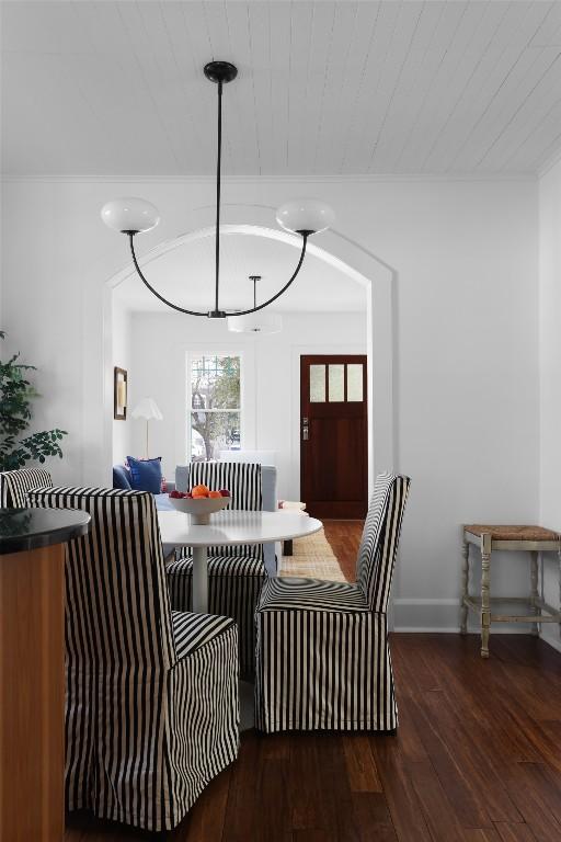 dining room featuring wooden ceiling, baseboards, and wood finished floors