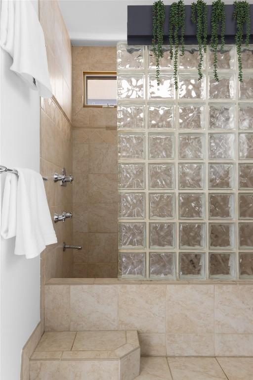 bathroom featuring tile patterned flooring and a walk in shower