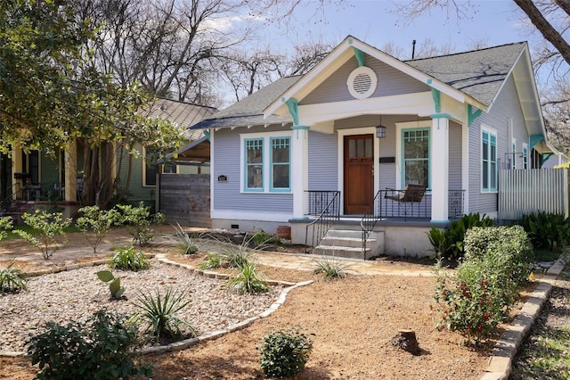 view of front of house featuring covered porch, roof with shingles, and crawl space