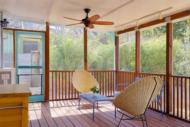 sunroom / solarium featuring ceiling fan