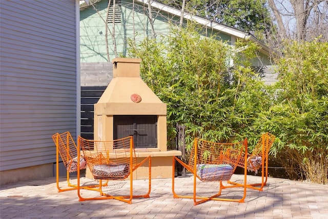 view of patio featuring an outdoor fireplace