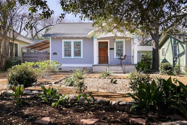 view of front facade with a porch, crawl space, and a shingled roof