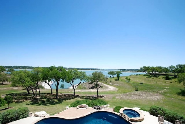 exterior space with a water view and a jacuzzi